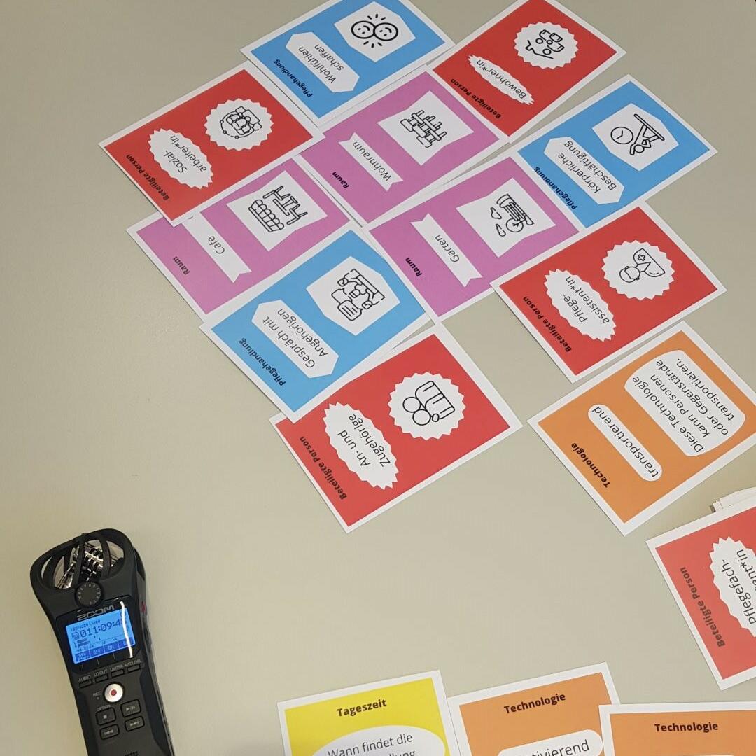 Picture taken during card workshops, with audio recorder and cards on care actions on the table